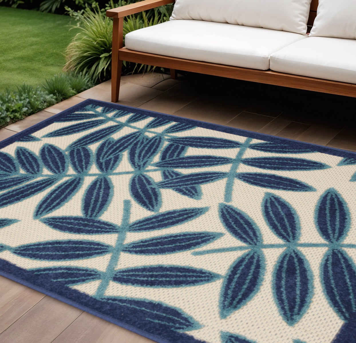 8' X 11' Navy Blue And Ivory Palm Leaf Indoor Outdoor Area Rug